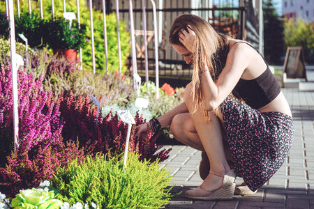 A girl looking at flowers photo