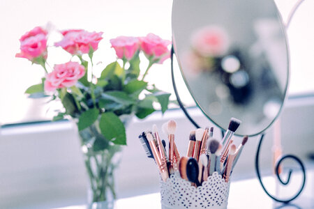 Makeup brushes and roses photo
