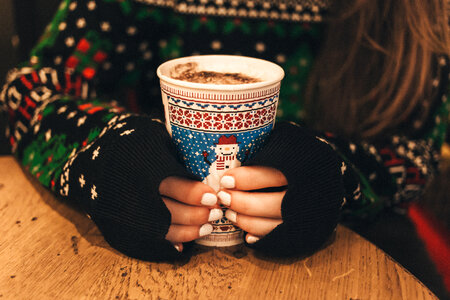 Girl holding christmas coffee cup photo