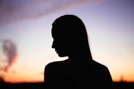 Girl’s head silhouette at sunset 2 photo