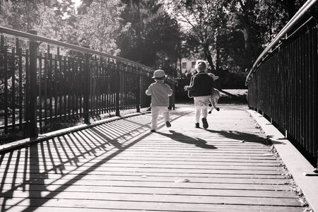 Kids running across the bridge 2 photo