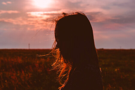 Girl’s head silhouette at sunset photo