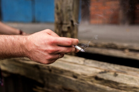 Cigarette in a male hand photo