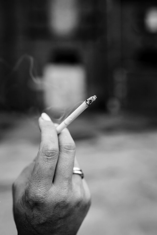 Hand holding a cigarette photo