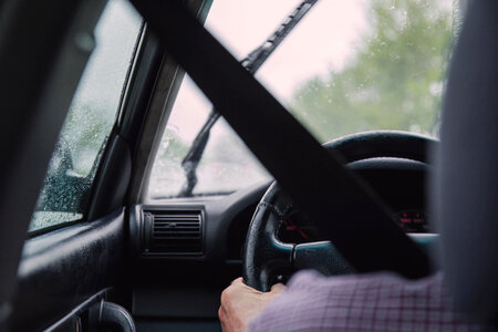 Man driving on a rainy day photo