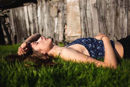 Girl laying on grass photo