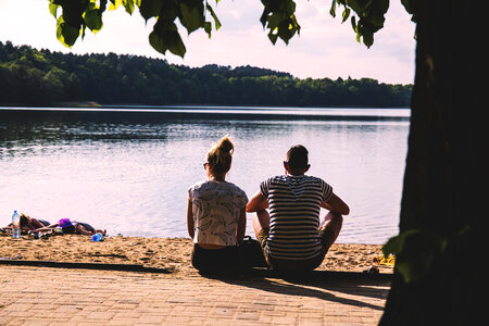 Couple sitting on the beach photo
