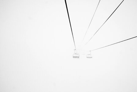 Black and White Image of Two Ski Lifts photo