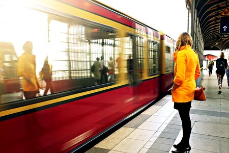 Woman Standing Beside Red Train photo