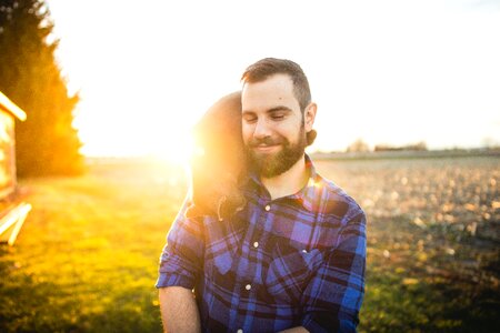 Black Cat on Man's Shoulder during Golden Hour