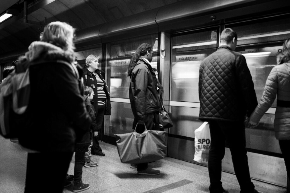 Man on Black Jacket Holding Woman on Brown Jacket