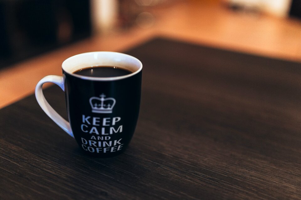 Black and White Ceramic Mug on Wooden Table photo