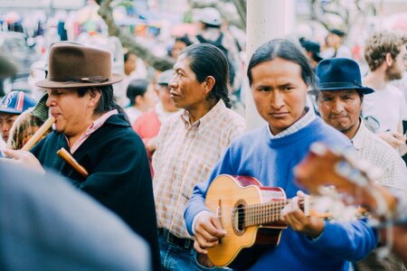 Man Playing Acoustic Guitar Beside People during Daytime
