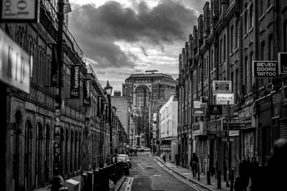 Black and White Photo of Street and Builldings With People photo