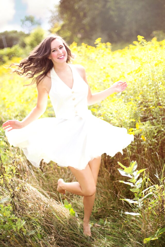 Woman Running Surrounded by Grass photo