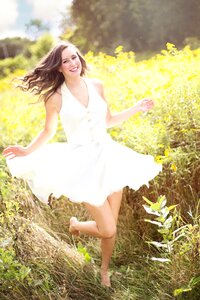 Woman Running Surrounded by Grass photo