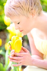 Woman Wearing Yellow Dress Holding Yellow Tulip Flower photo