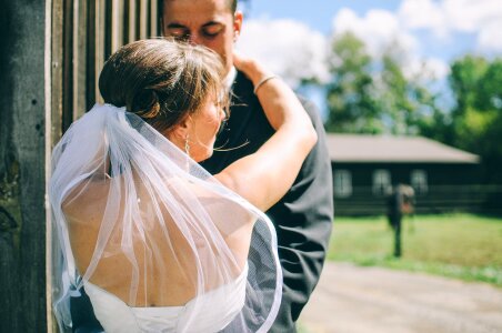 Bride and Groom Hugging Each Other during Daytime photo