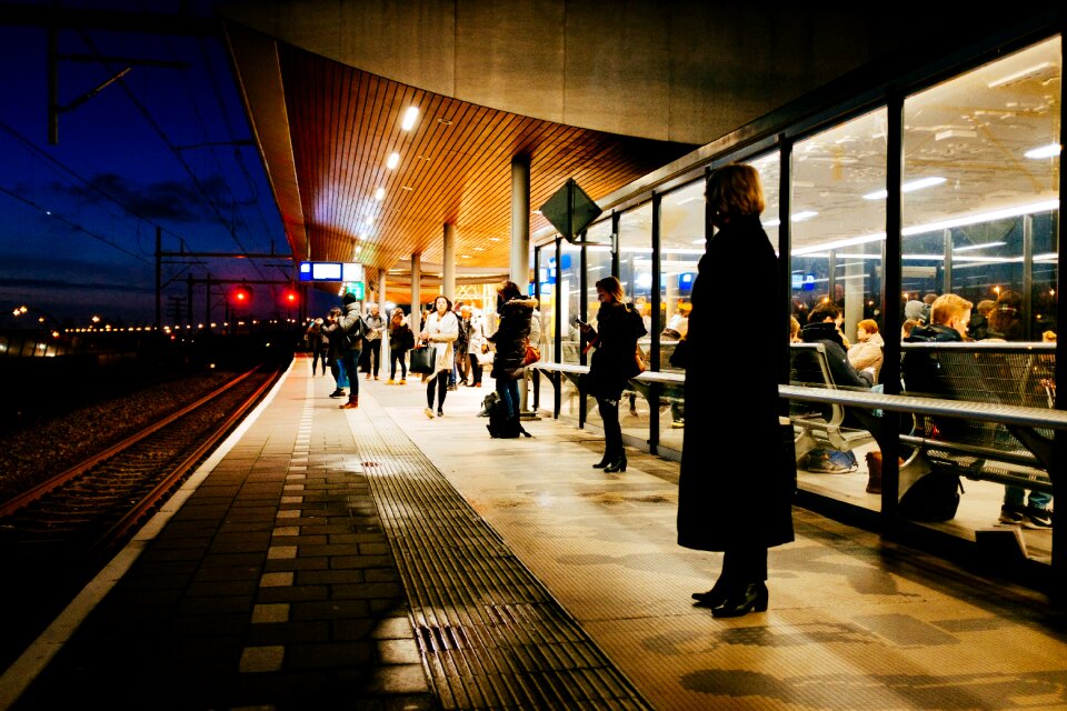 People Waiting on Train Station Platform at Night photo