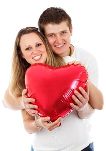 Man and Woman Holding Inflatable Heart photo