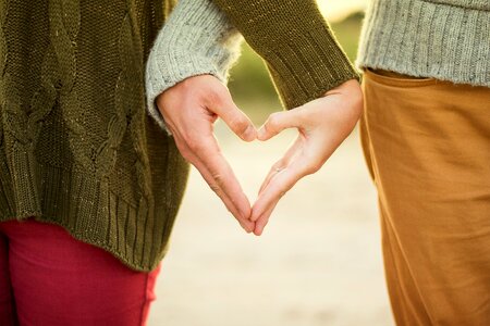 Selective Focus Photography Two Person Making Heart Hand Sign photo