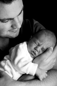 Grayscale Photo of Man Holding Baby photo