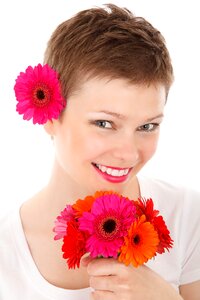 Woman Holding Flowers While Smiling photo
