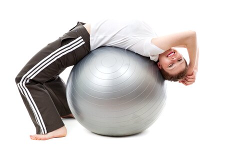 Woman in White Cap Shirt on Stability Ball photo
