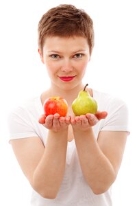 Woman Holding Red Apple and Green Peach photo