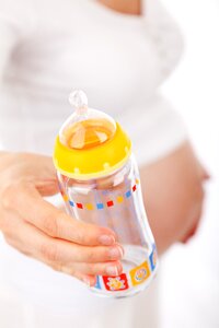 Baby's Feeding Bottle on Hand photo
