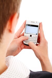 Person in White Top Using White Qwerty Phone photo