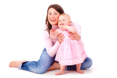 Woman Holding the Waist of Baby Girl in Pink Dress photo