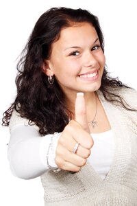 Smiling Woman Wearing White and Beige Showing Thumbs Up photo