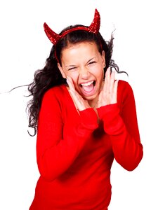 Shouting Woman Wearing Red Devil Horns Headband photo
