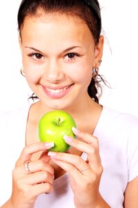 Smiling Woman Holding Green Apple Fruit photo