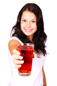 Woman in White Shirt Showing a Filled Drinking Glass photo