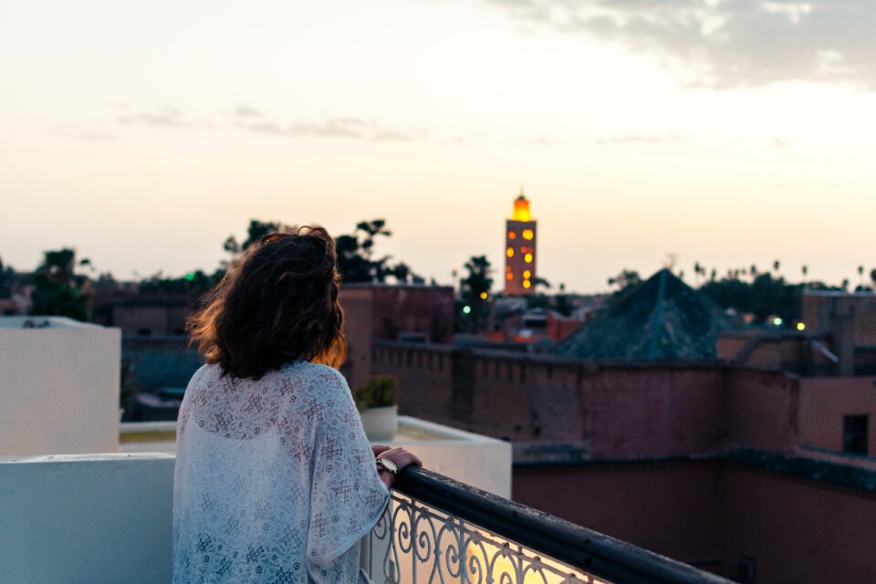 Woman in White Lace Top Holding on Black Handrail
