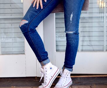 Person in Blue Denim Jeans and White Converse All Stars photo
