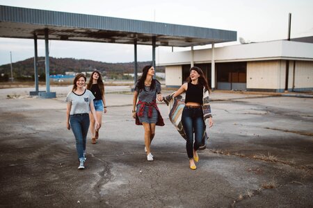 Four Women Walking in Station Under Clear Sky photo