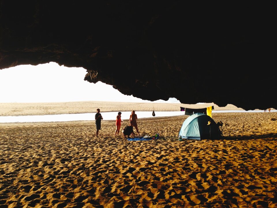 People on Beach by Blue Tent