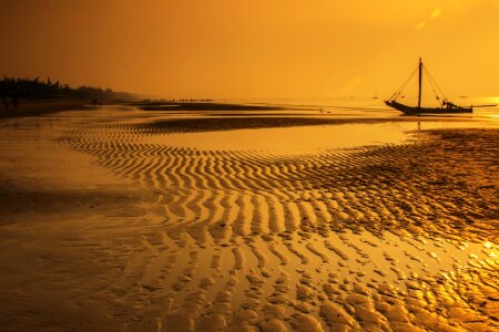 Sea Water With Boat during Sunset photo