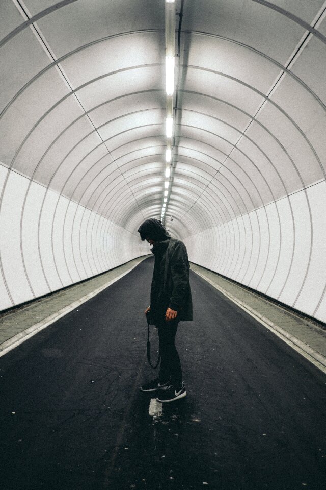 Man in Black Hoodie Standing Inside Panel