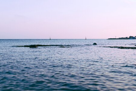 Body of Water Near Buildings Under White Sky photo