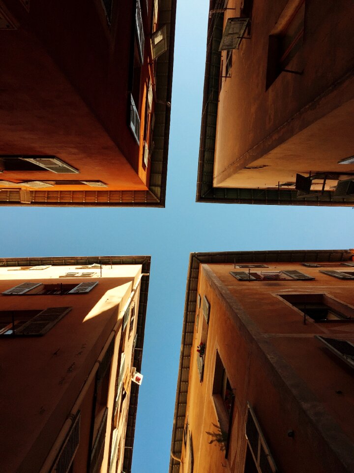 Worms Eye View of 4 Brown Concrete Buildings at Daytime photo