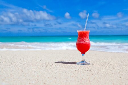 Red Slush Drink in Glass on Beach photo