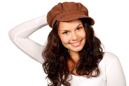 Woman in White Scoop Sleeved Shirt and Brown Cap Smiling photo