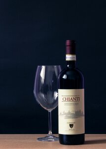 Chianti Labeled Bottle and Clear Long Stem Glass on Table photo