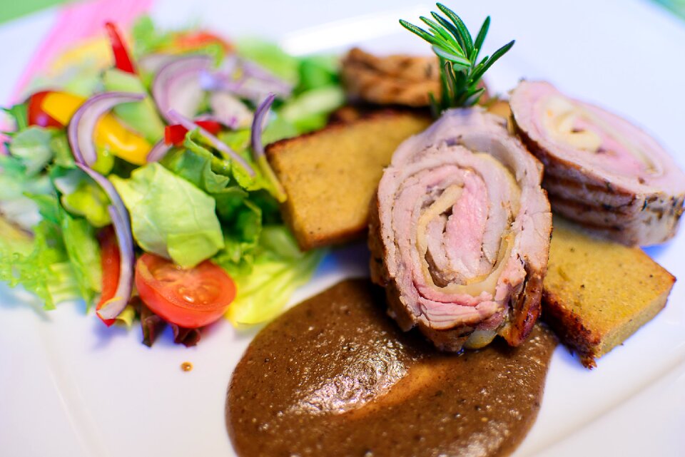 Roasted Meat on a Gravy Beside a Garden Salad