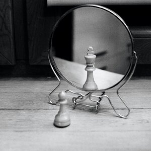 Grayscale Photo of Reversible Mirror in Front of Chess Piece photo