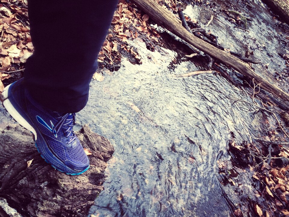 Person in Navy Blue Sweatpants and Blue and White Sneakers